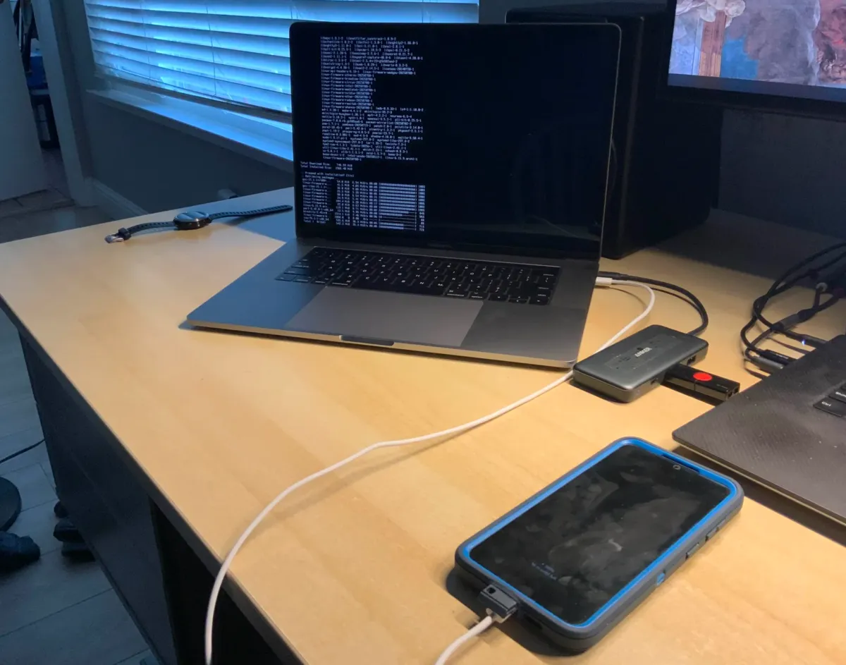 A macbook connected to a phone